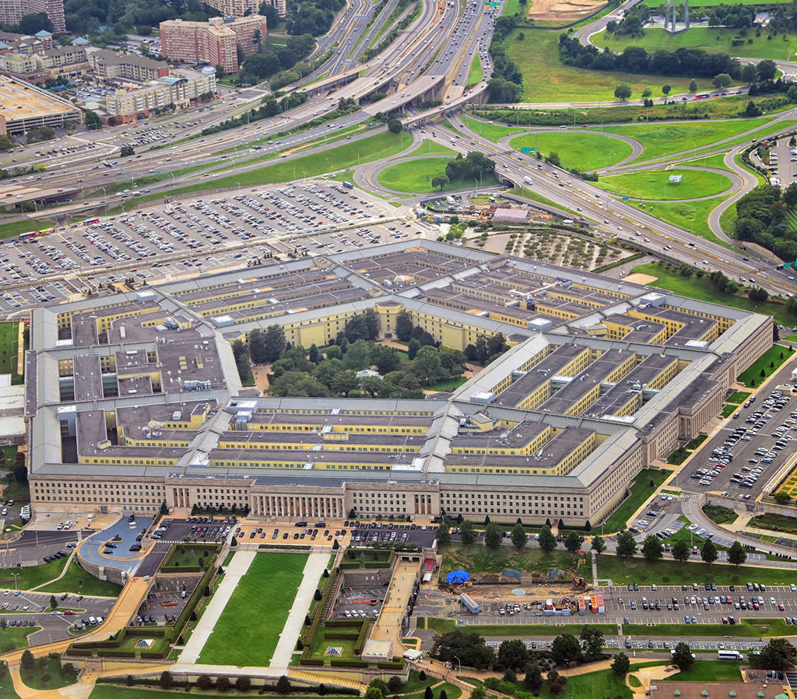 Aerial view of the Pentagon building, showcasing its distinctive five-sided structure and surrounding landscape.